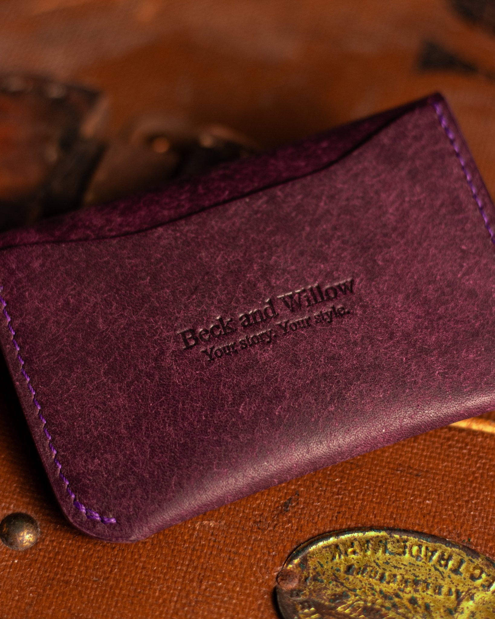 Close Up shot of Brand Logo on a leather card holder in italian Purple