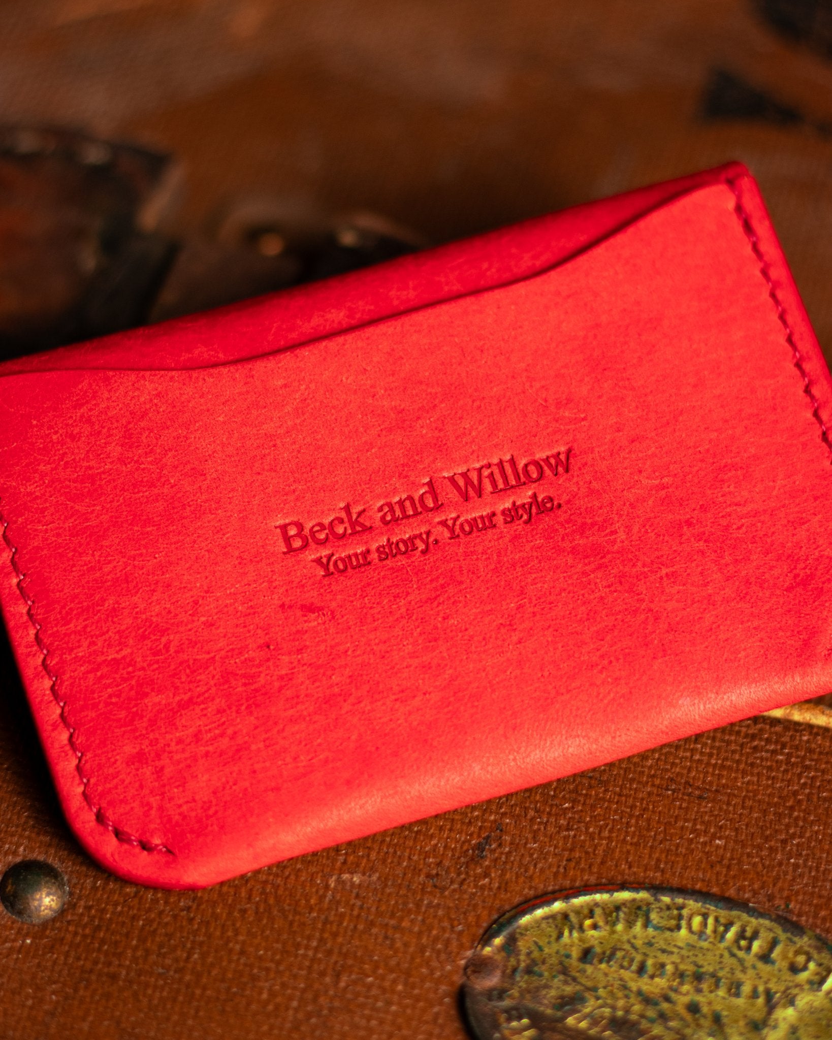Close Up shot of Brand Logo on a leather card holder in italian red