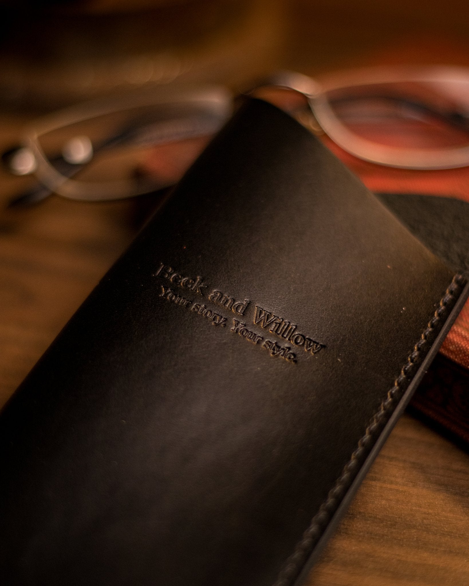 Close photo of brand stamp on a black italian leather glasses sleeve