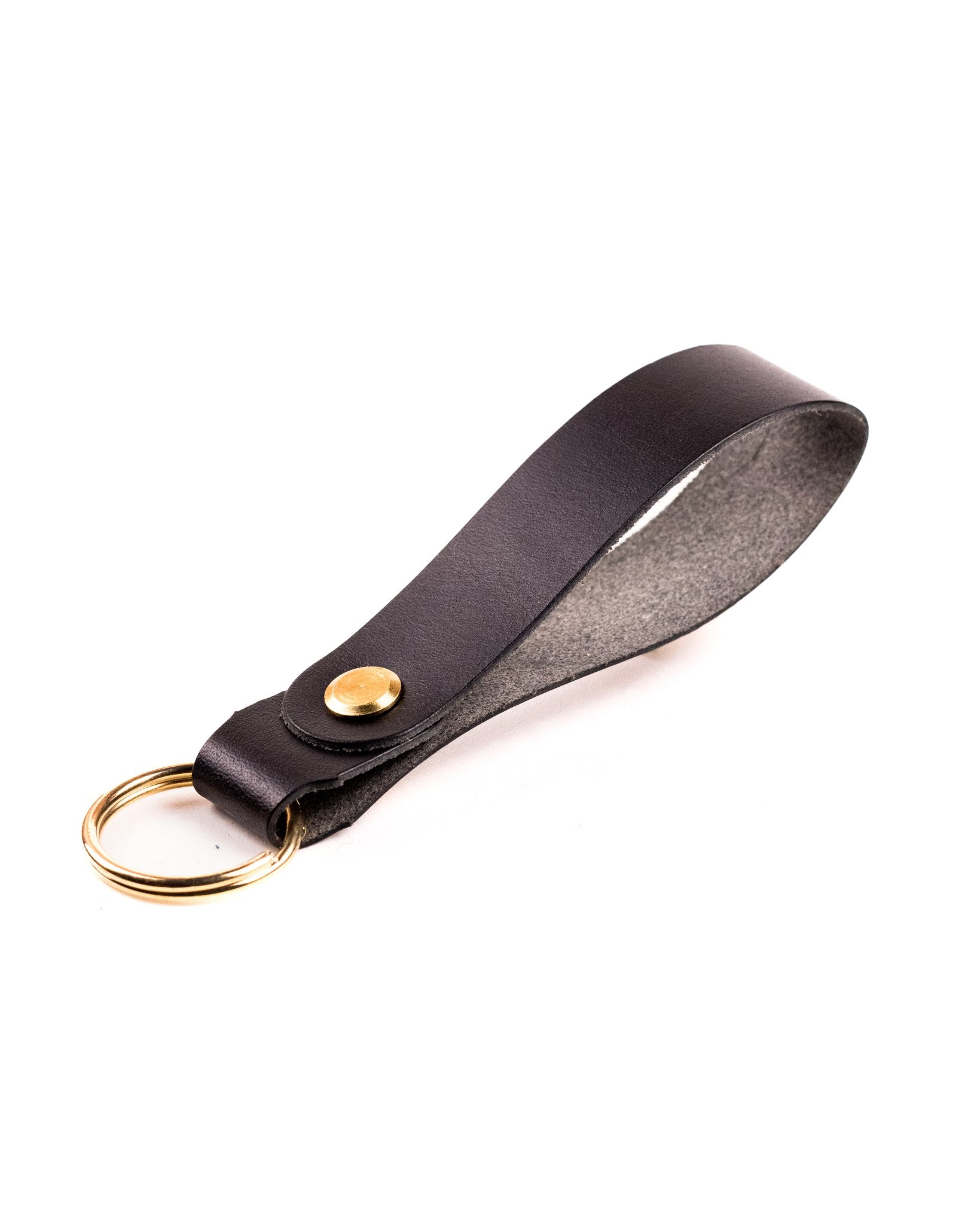 black italian leather keyring with brass hardware on a white background