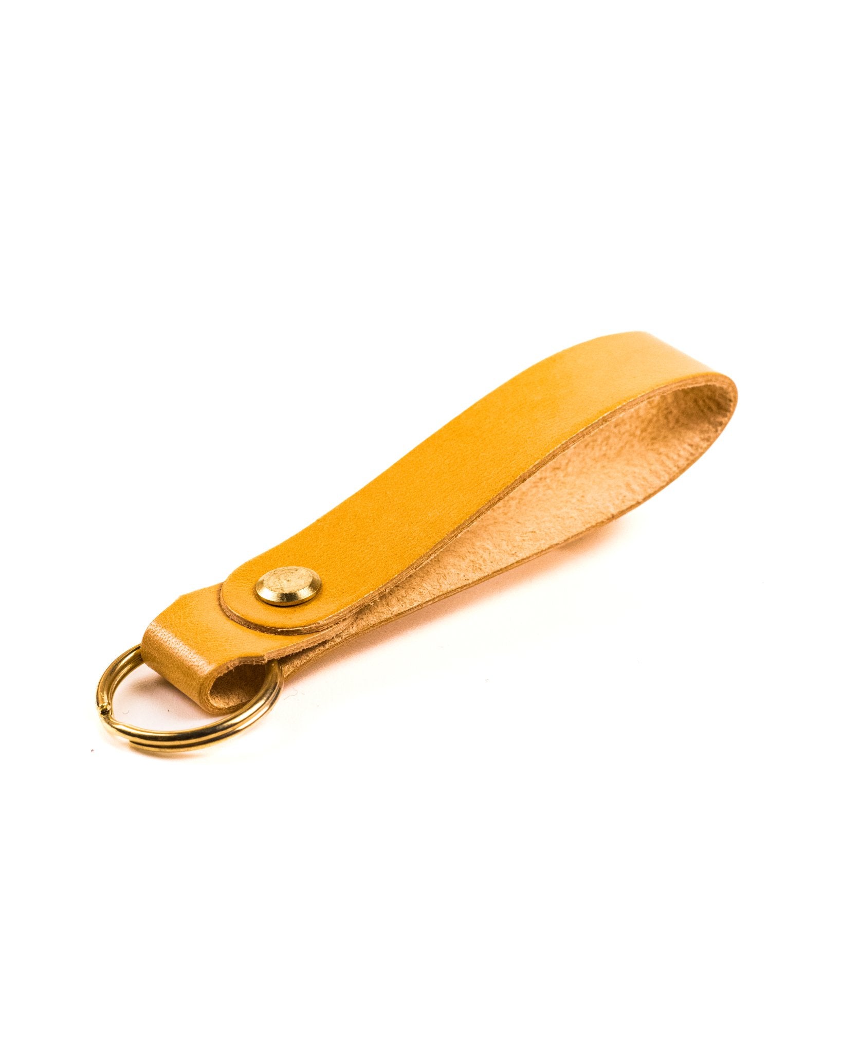 natural glazed italian leather keyring with brass hardware on a white background