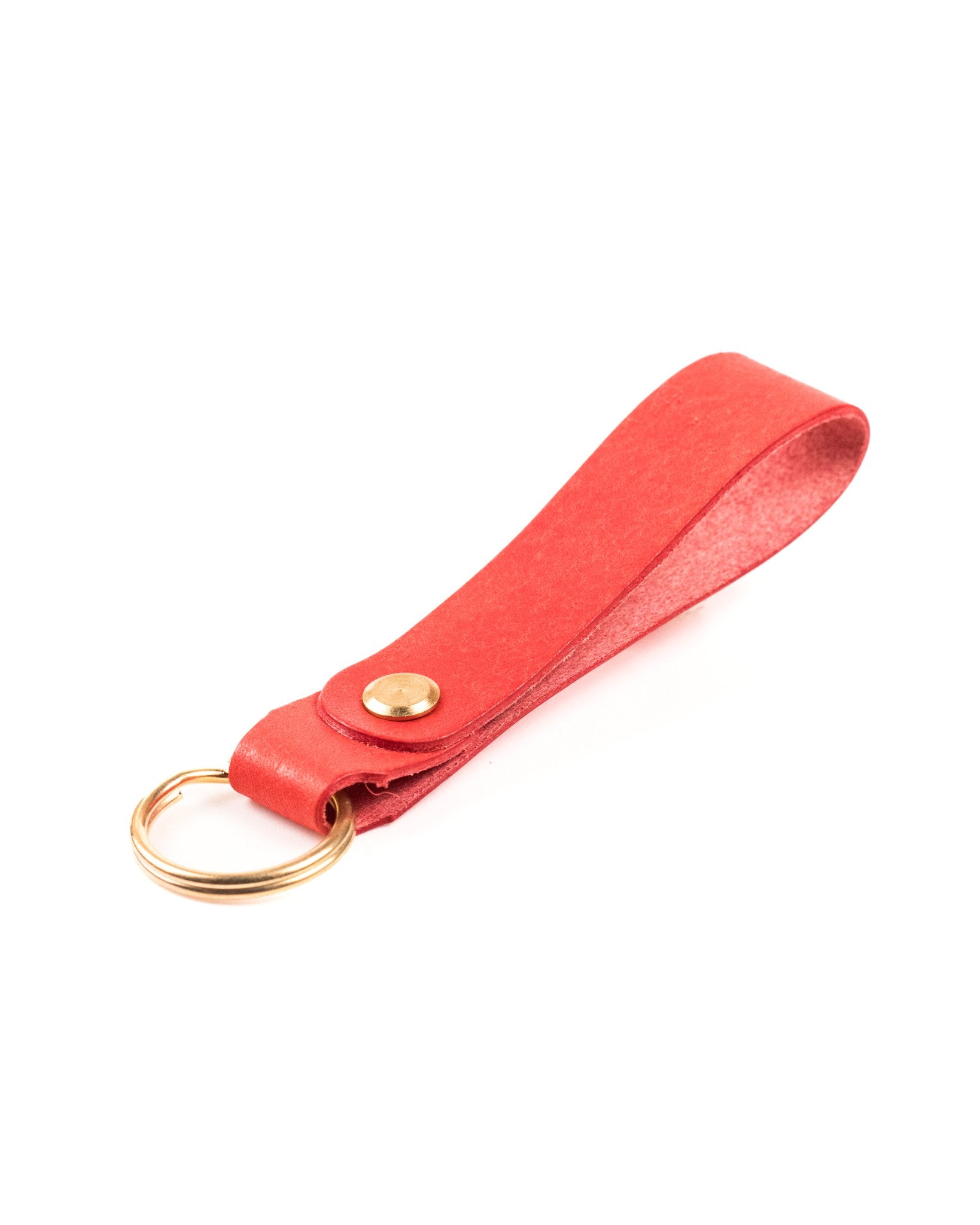 red italian leather keyring with brass hardware on a white background
