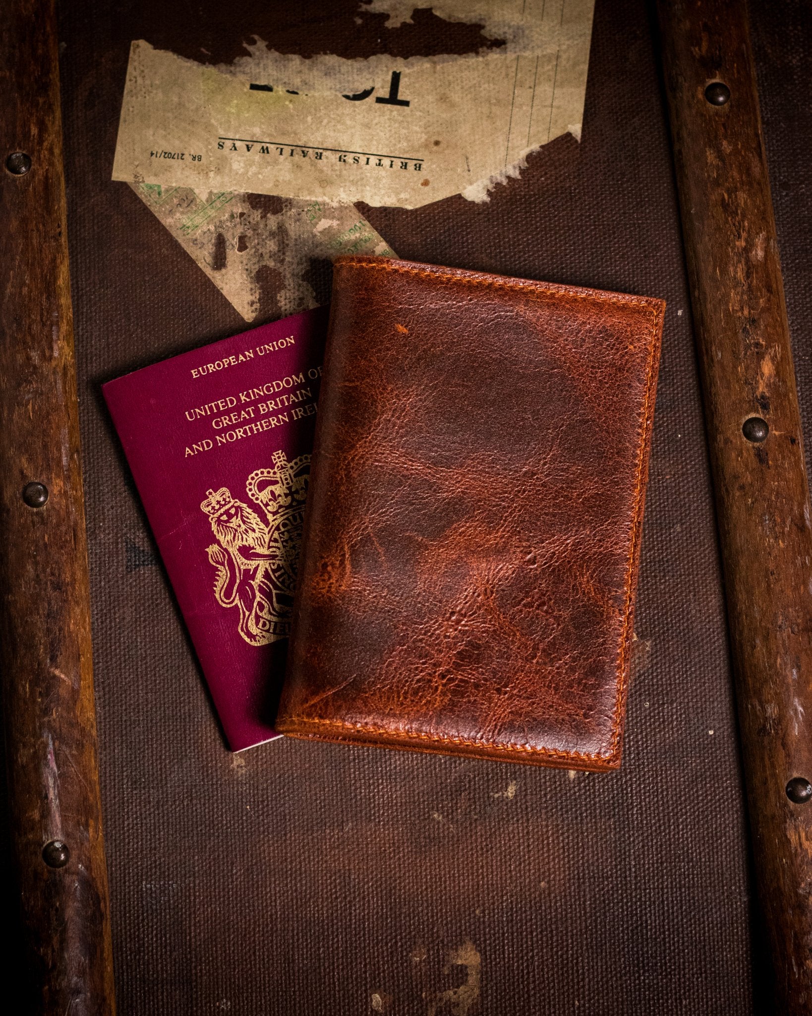 closed distressed tan passport cover with british passport