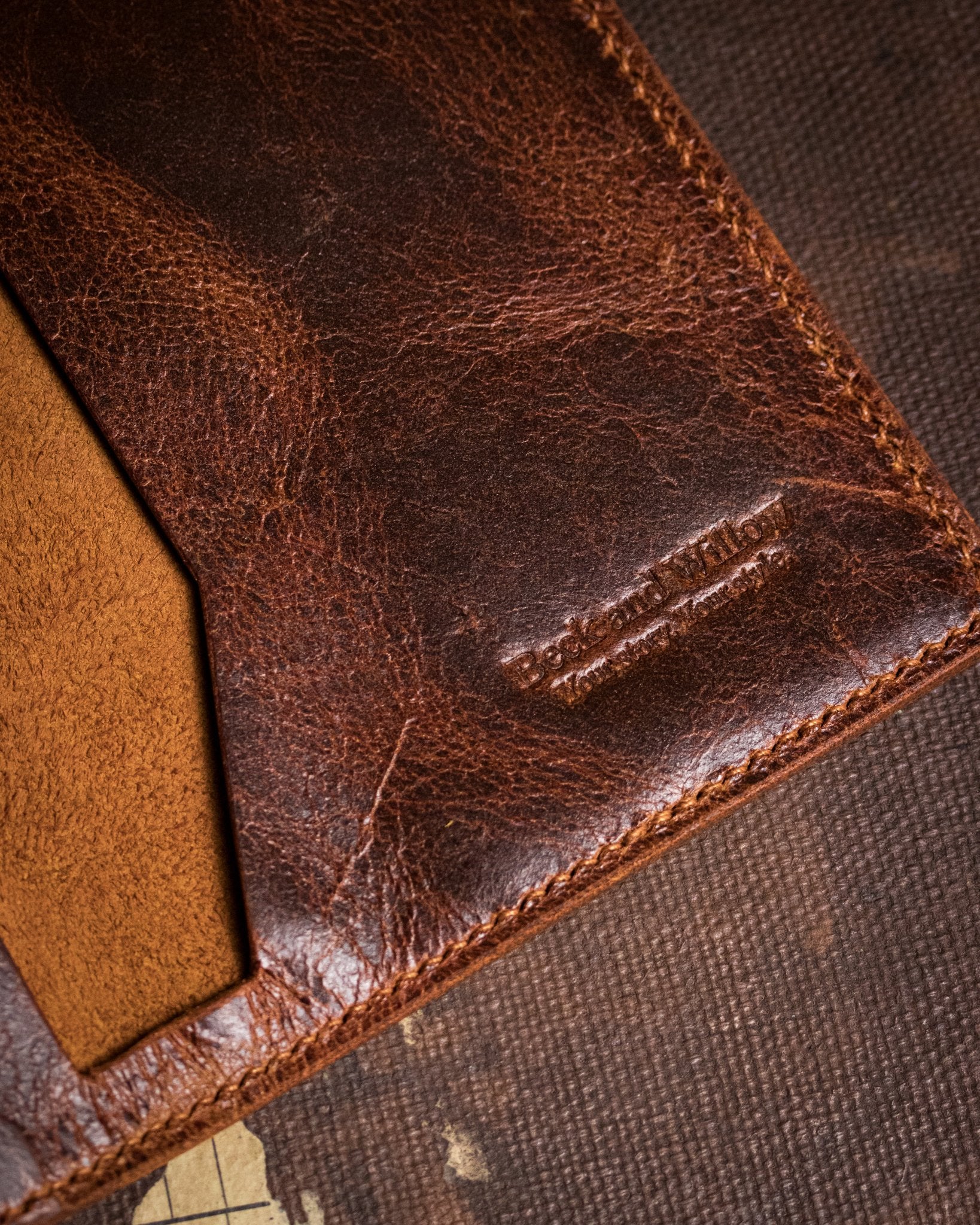 closeup shot of brand logo on distressed tan leather