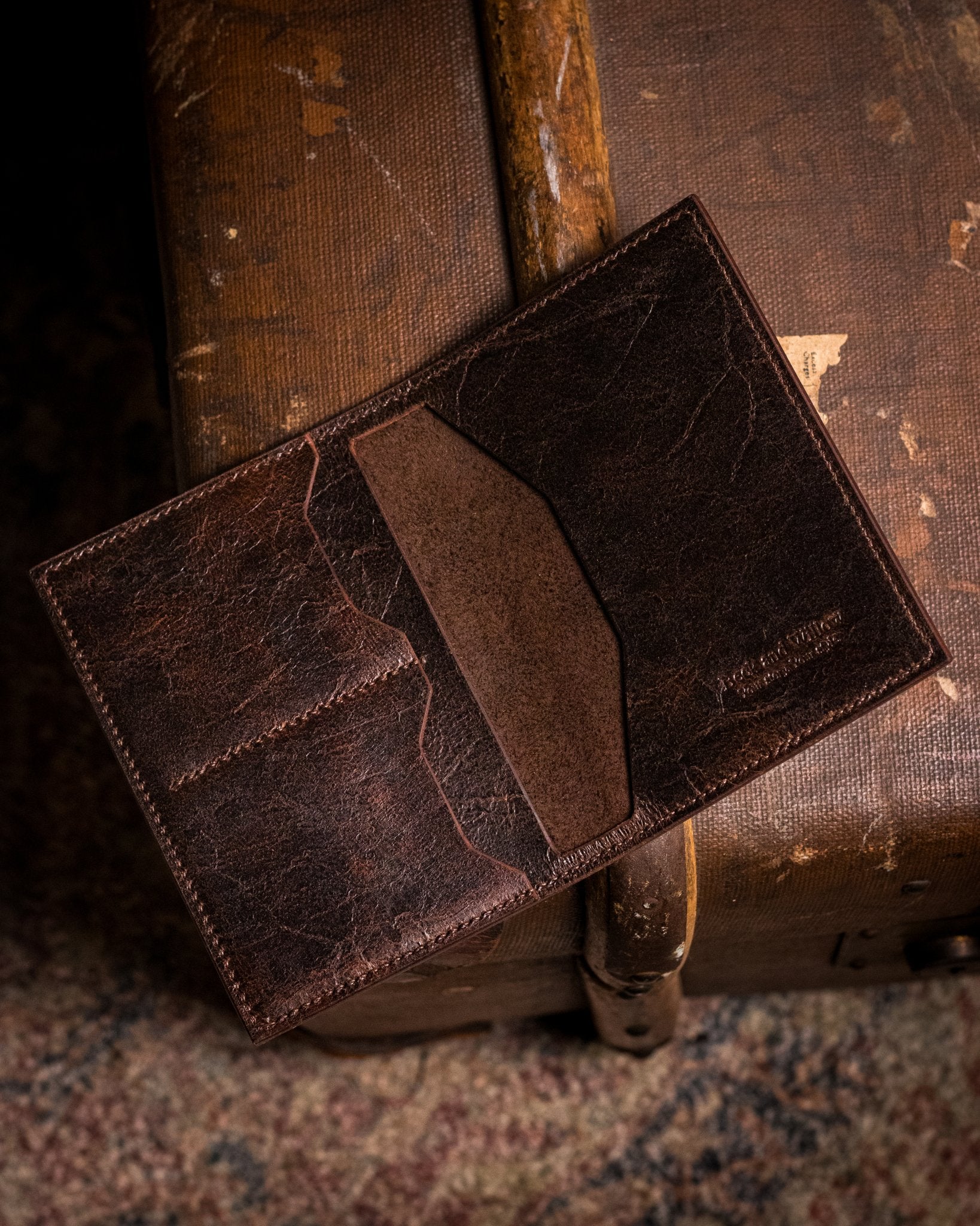 distressed brown passport holder on a travel trunk