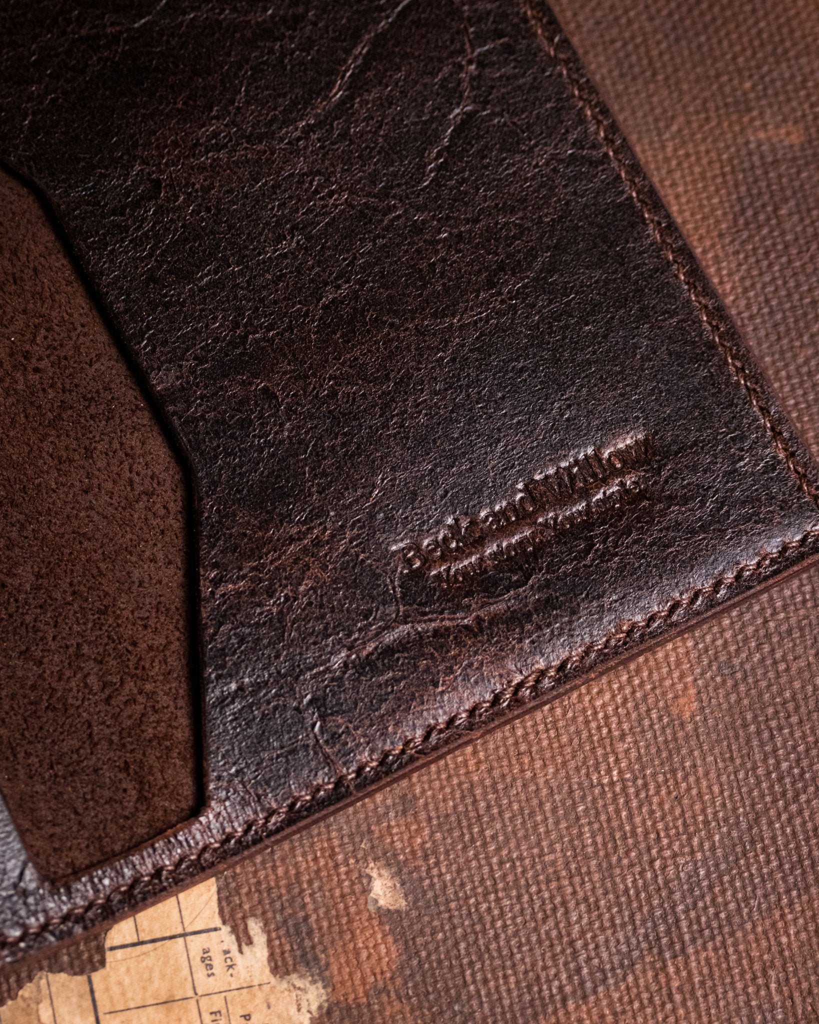 closeup shot of brand logo on distressed brown leather