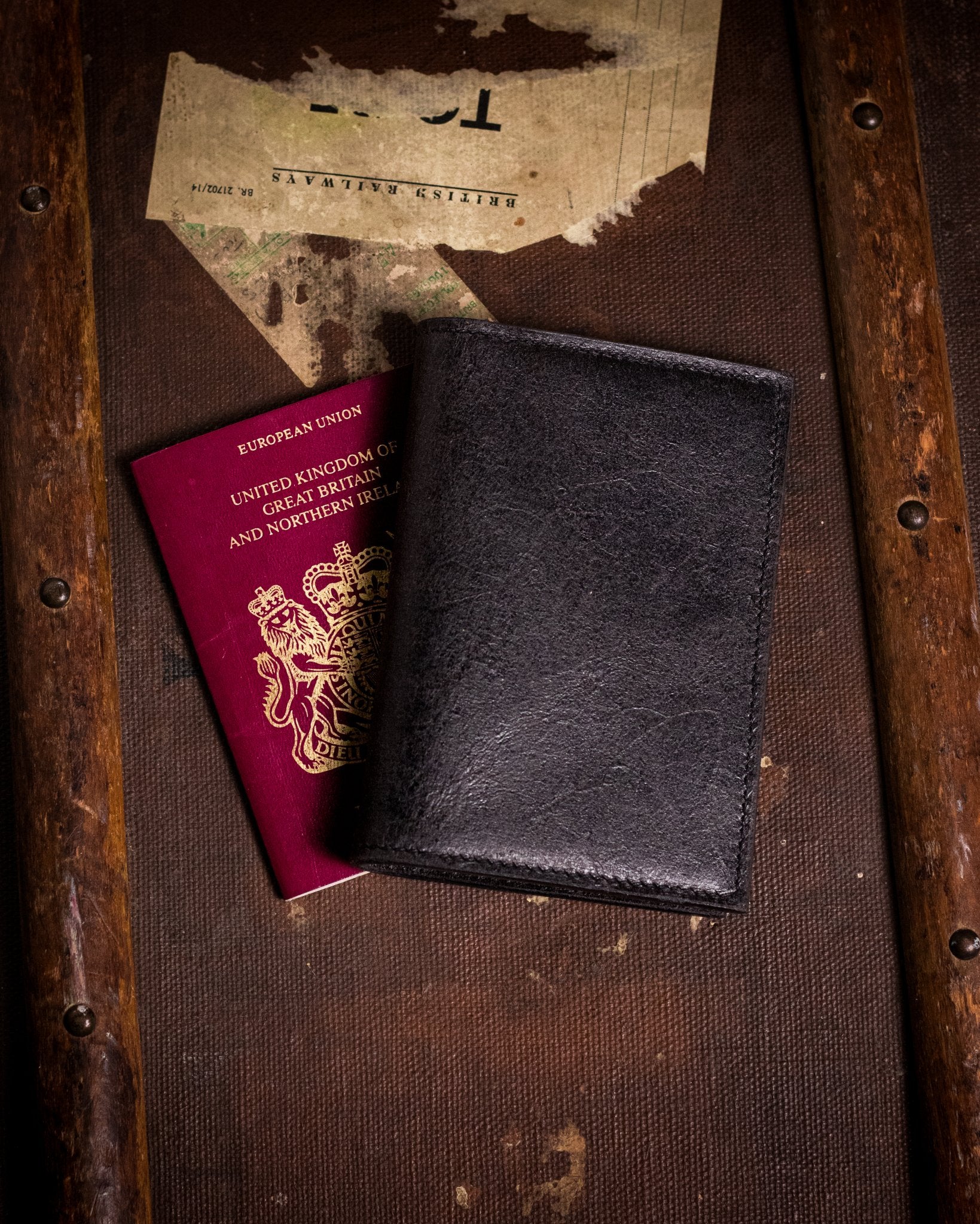 closed distressed black passport cover with british passport