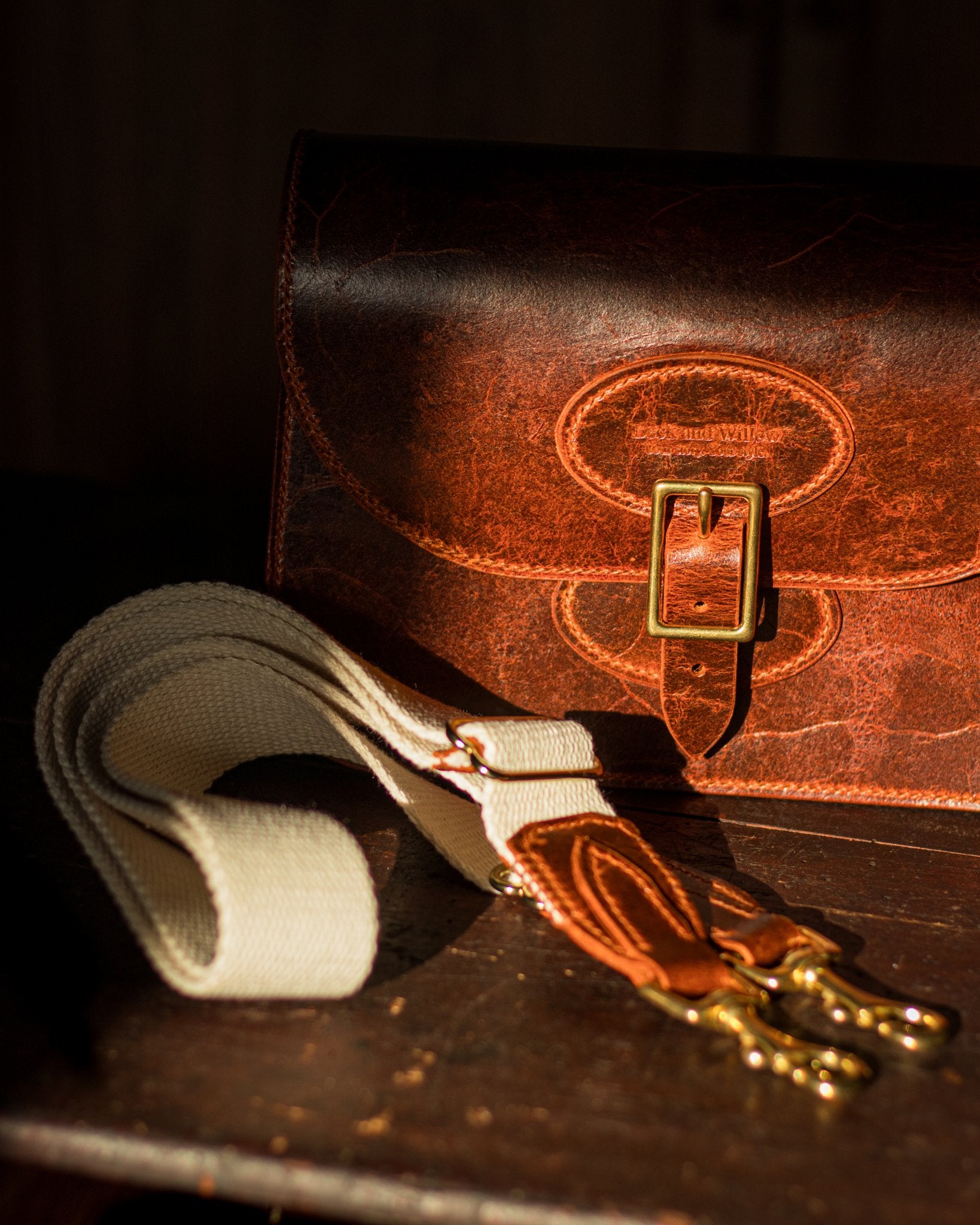 shadowed leather crossbody bag with cotton, leather and brass strap