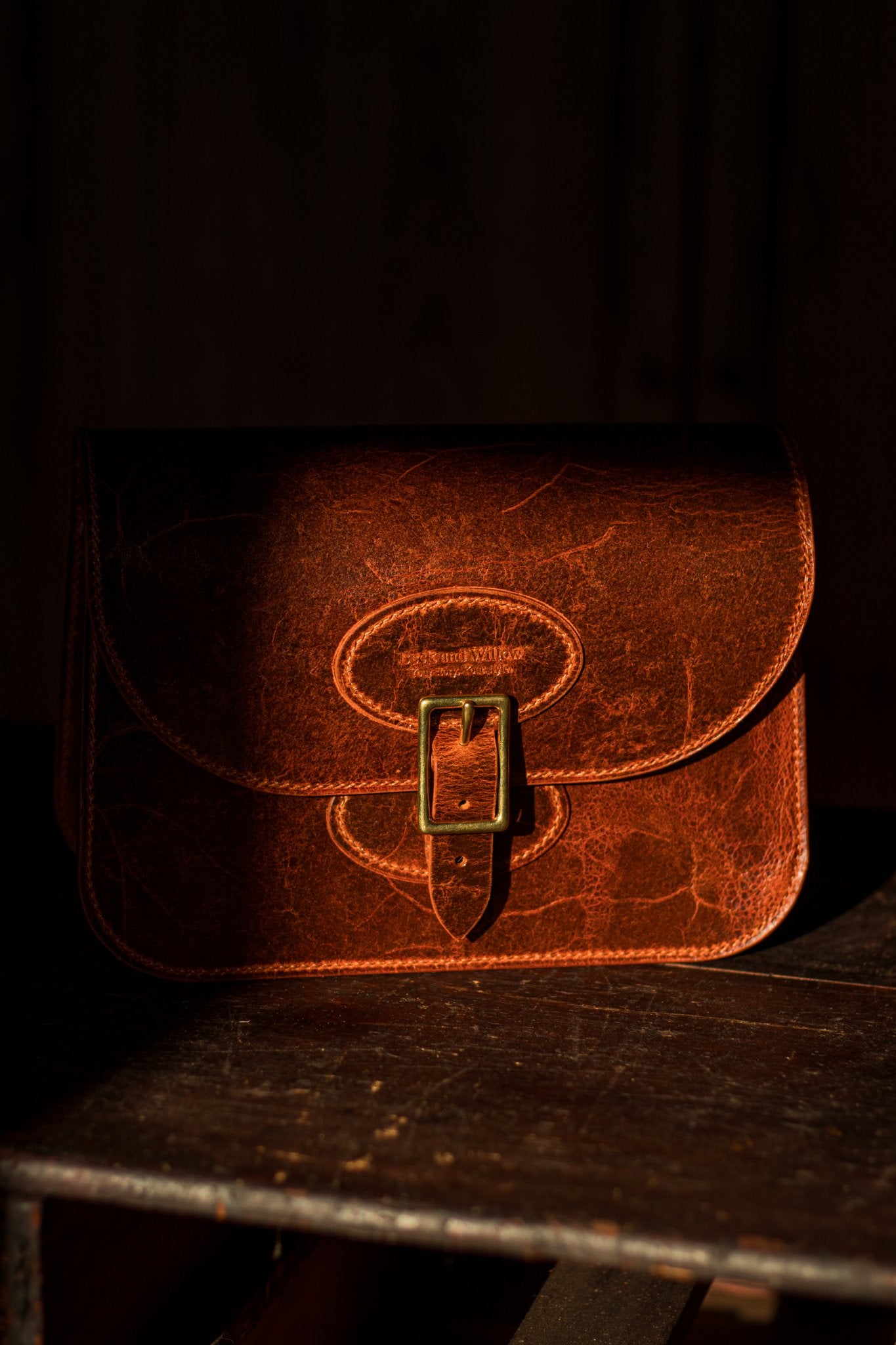 distressed tan bag in the shade with a golden ray of sun