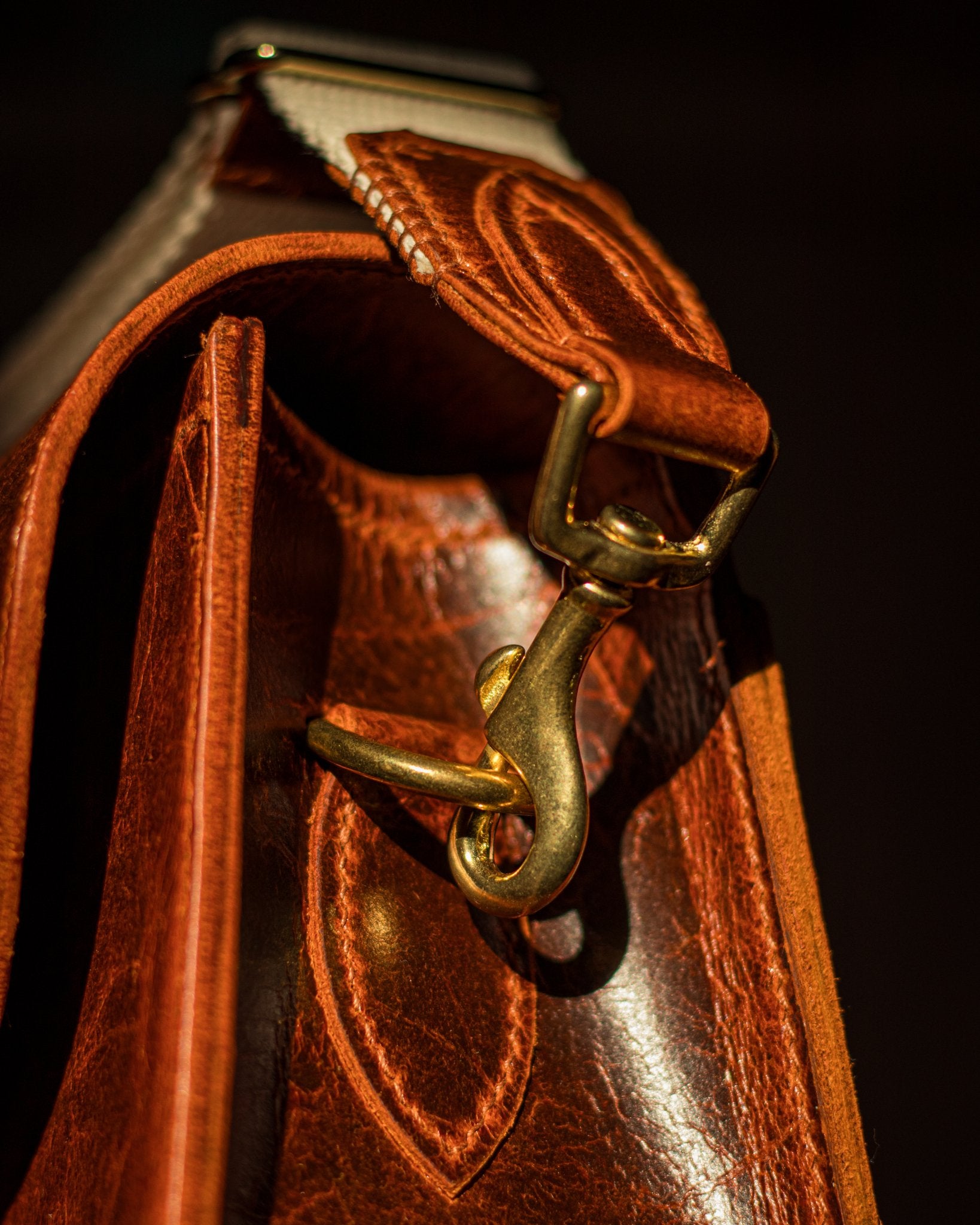 cotton, leather and brass strap attached to brass d ring