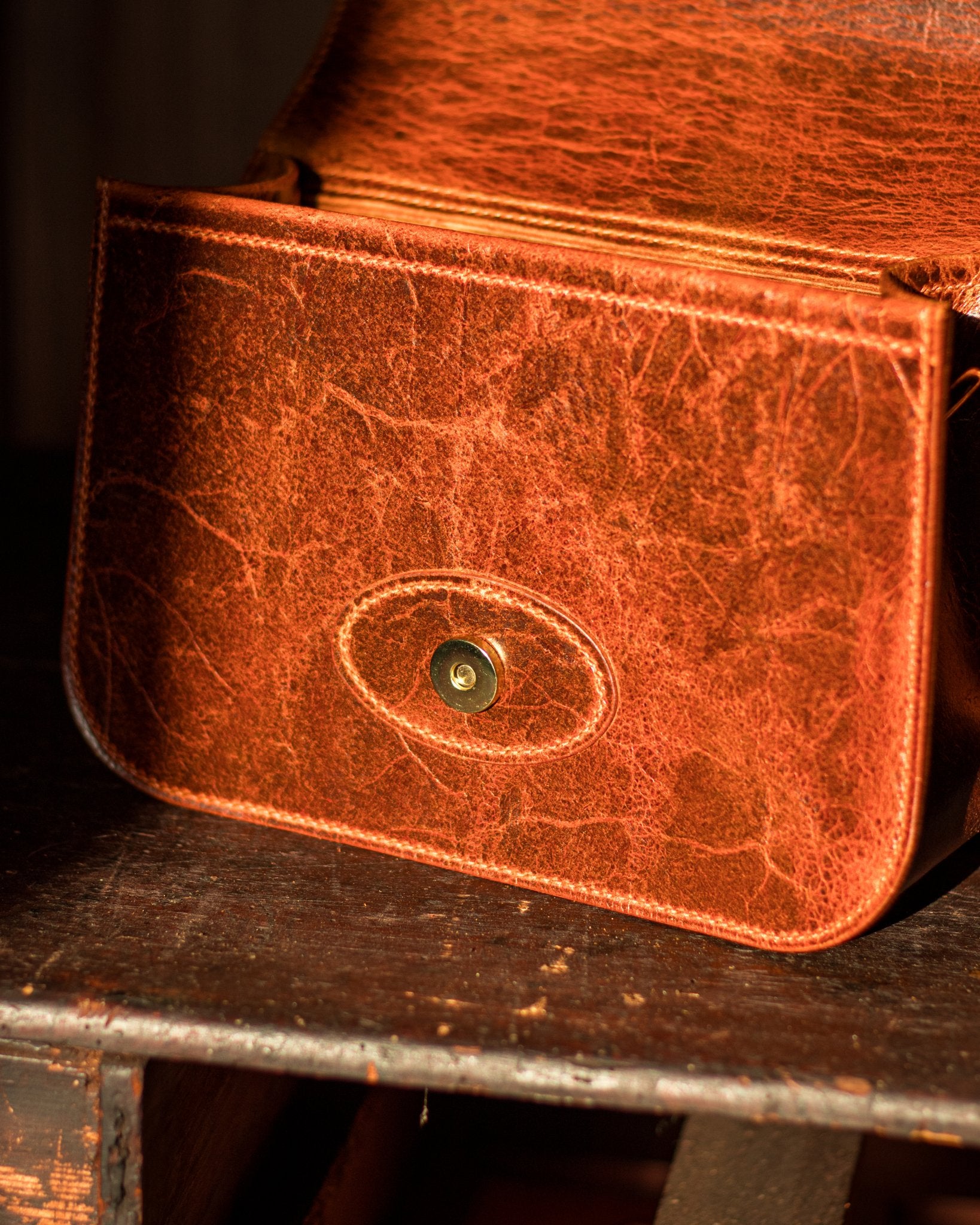 sunny golden picture showing the hidden magnet on an open leather handbag