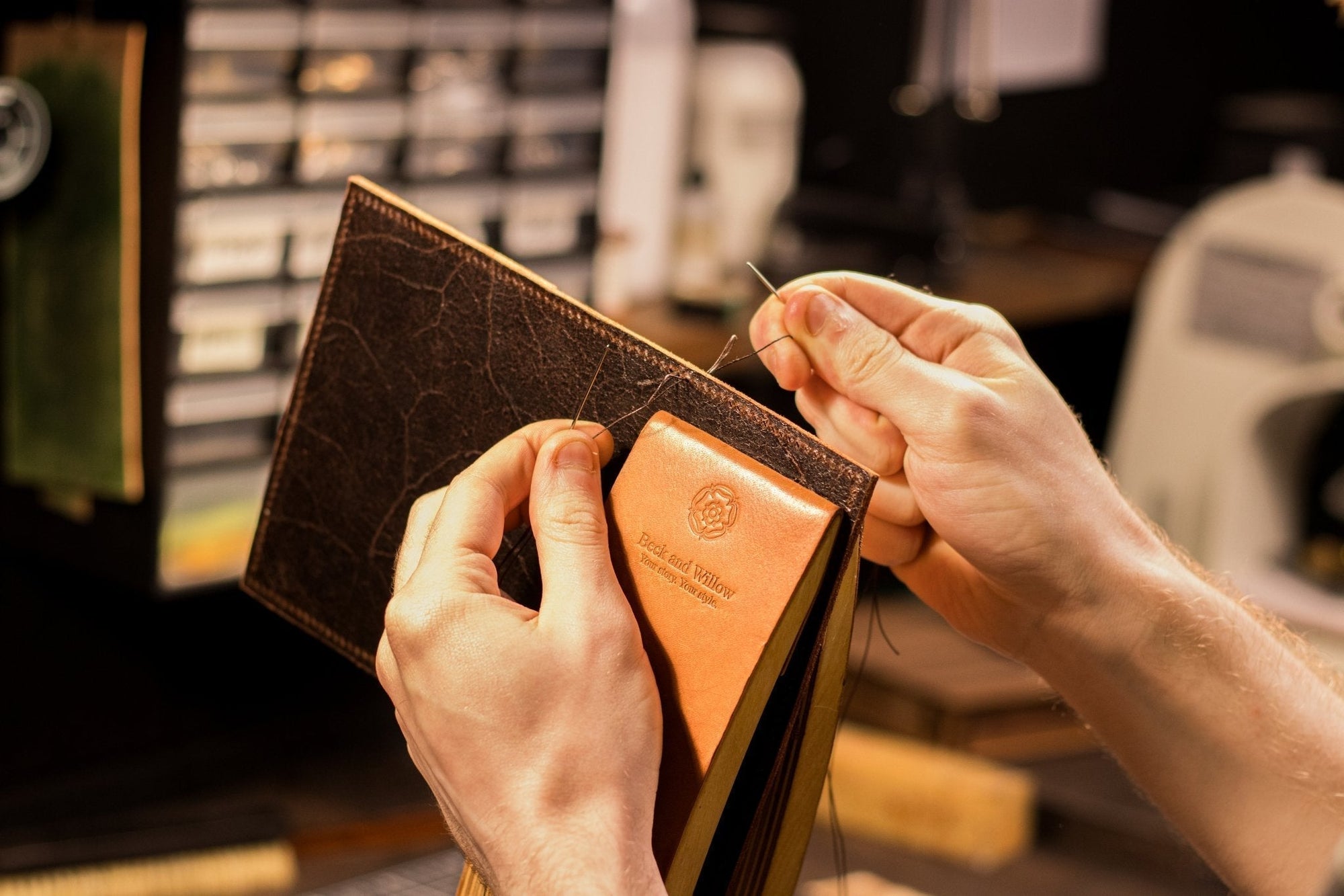 hands stitching leather passport cover
