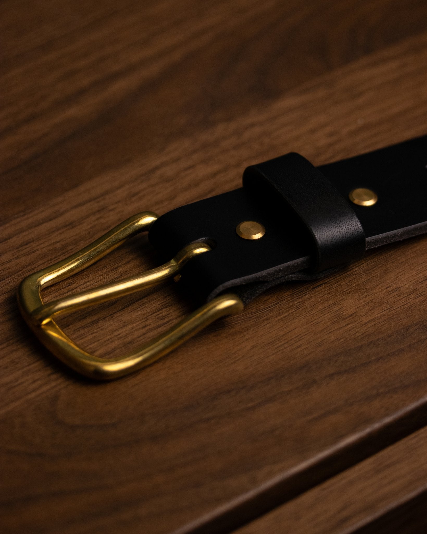 Vintage-style brass buckle on Black leather belt