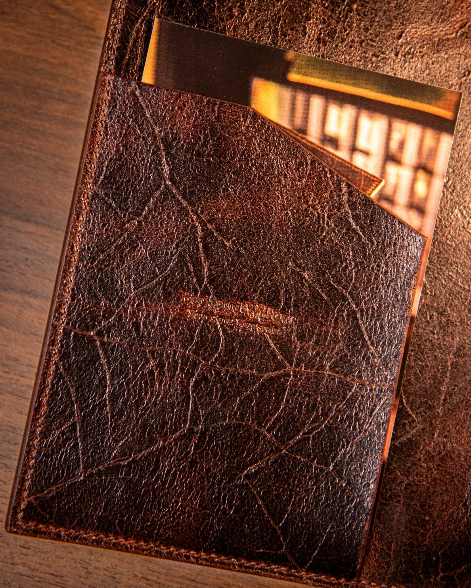 Brown leather notebook pocket on a wooden surface