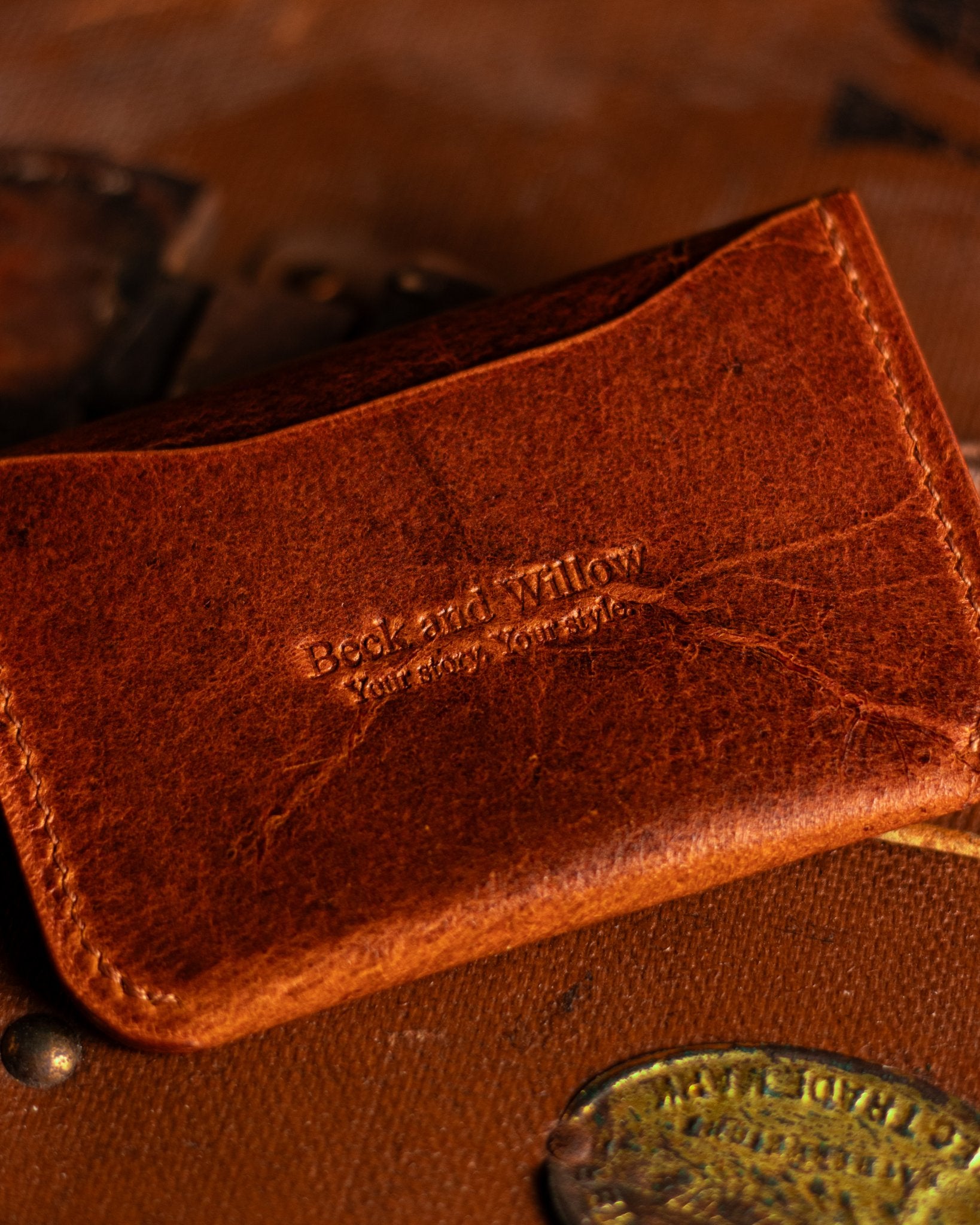 Close Up shot of Brand Logo on a leather card holder in distressed tan