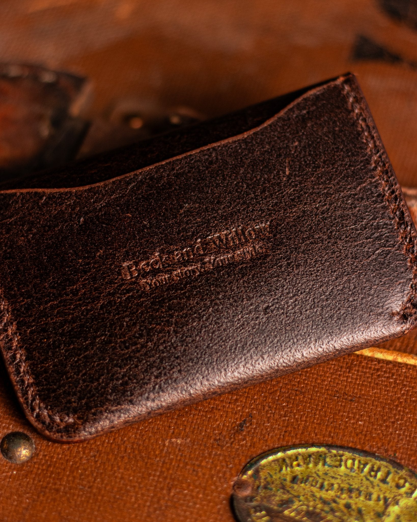 Close Up shot of Brand Logo on a leather card holder in distressed Brown