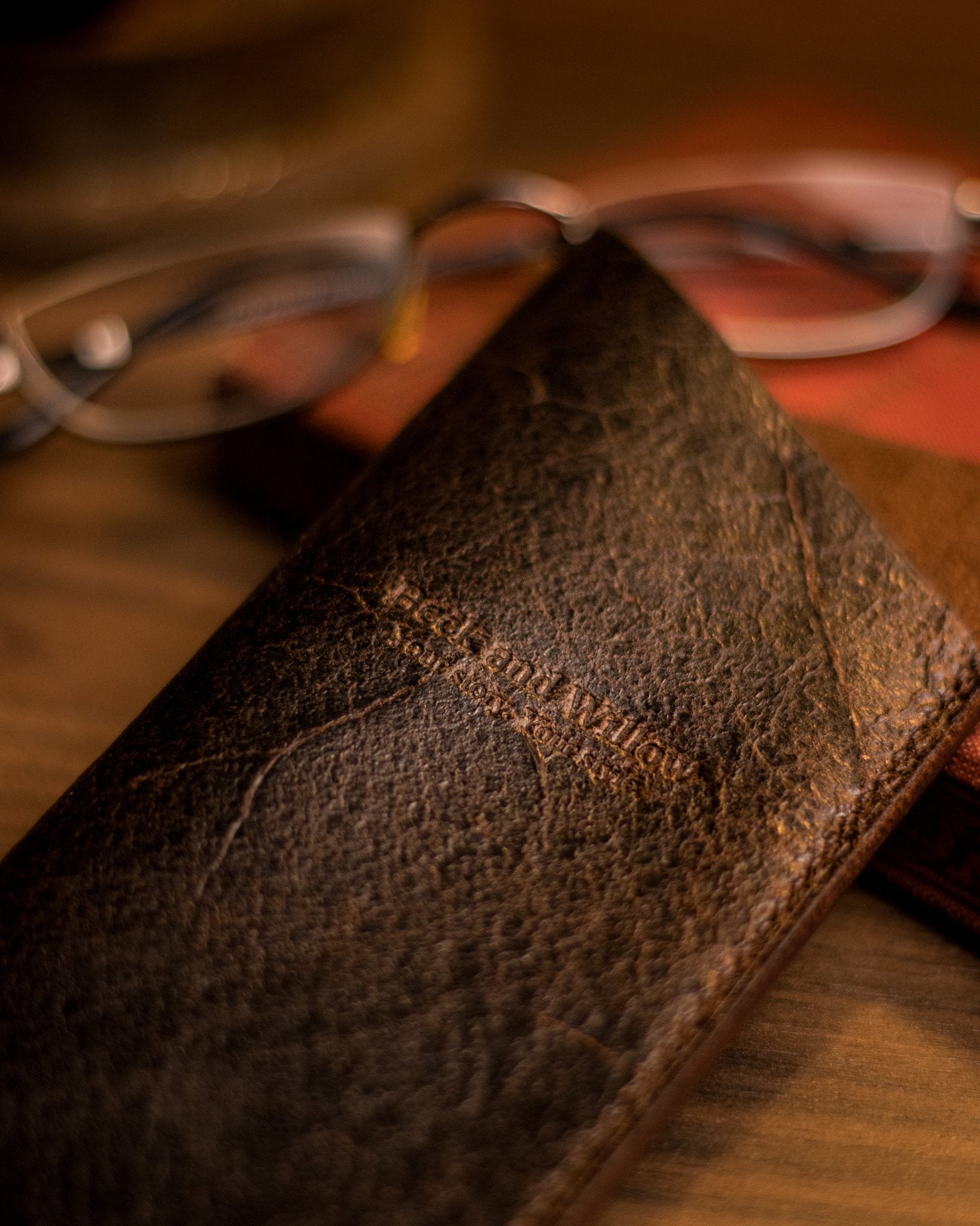 Close up shot of brand logo on a brown glasses sleeve