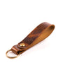 Tan Distressed leather keyring with brass hardware on a white background
