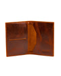 distressed tan leather passport cover on a white background