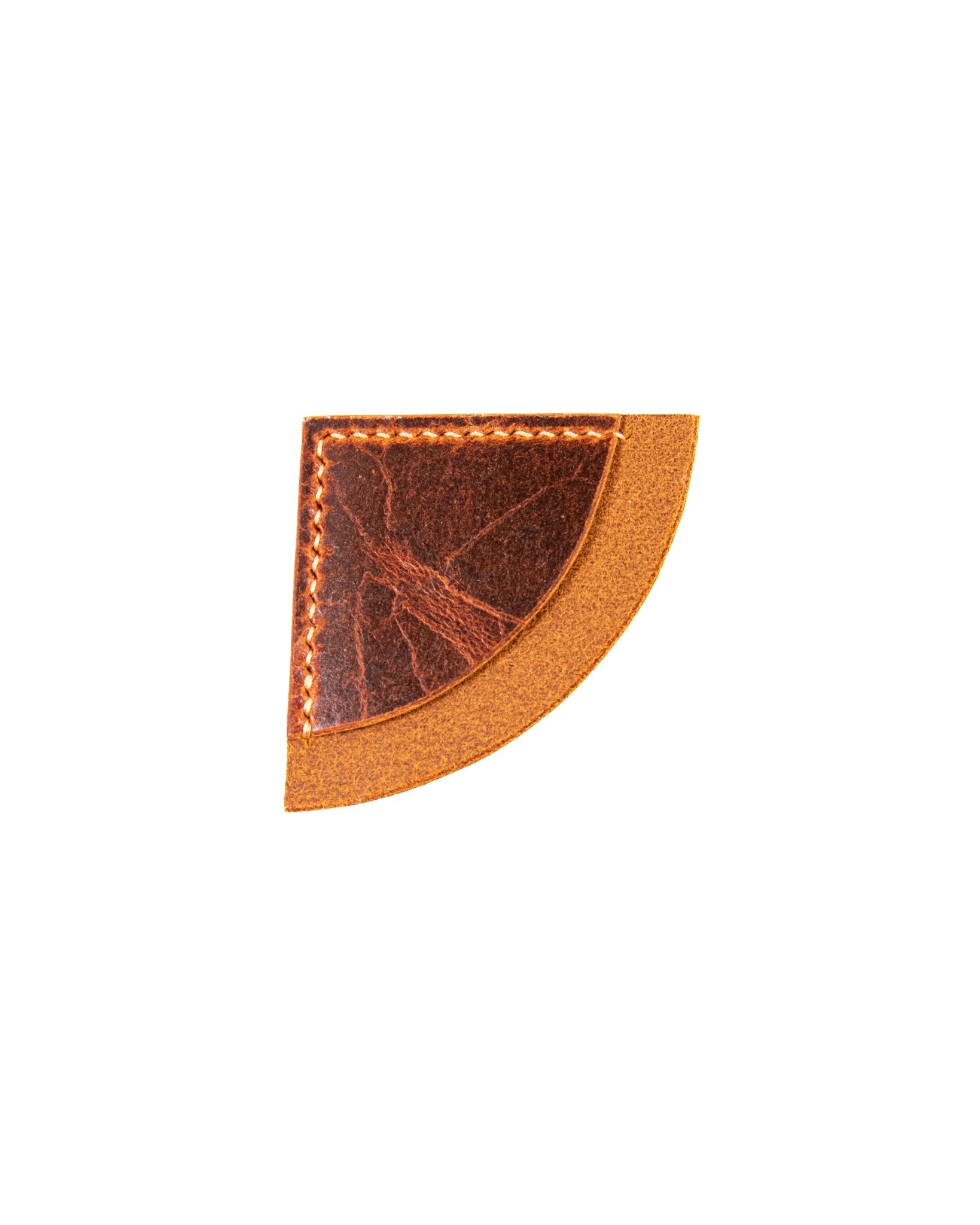 Tan leather bookmark with stitching on a white background