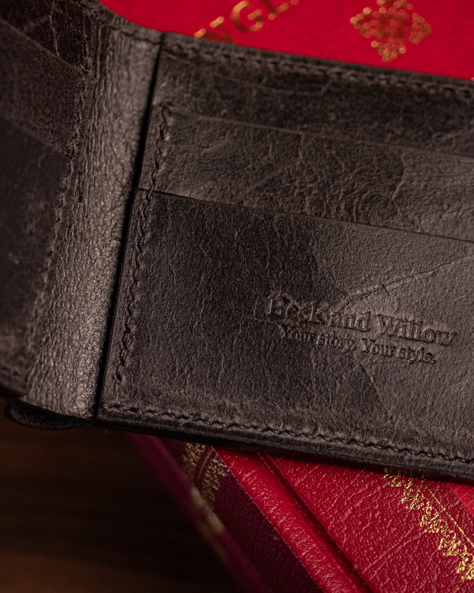close up shot of brand logo on distressed black leather wallet