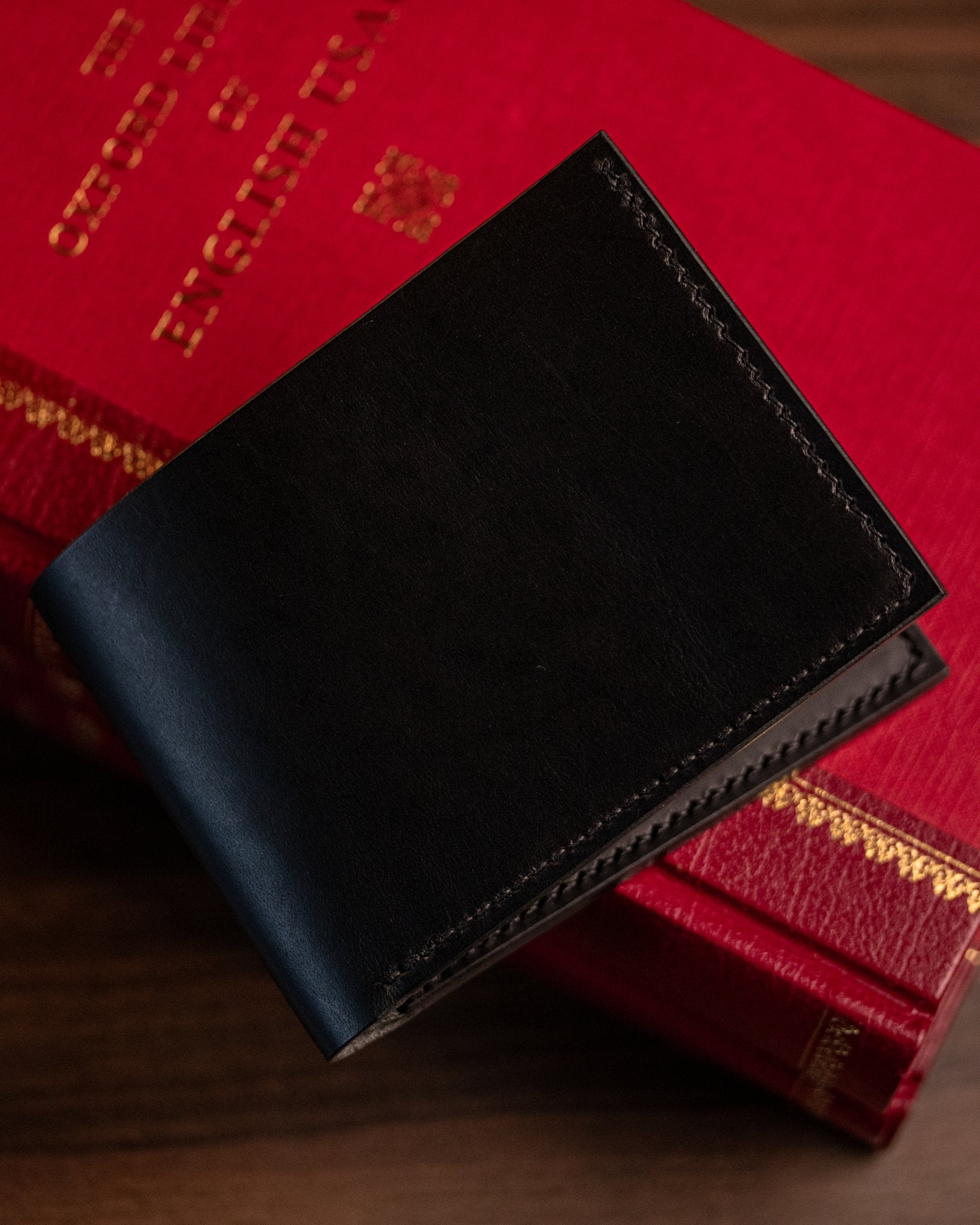 closed black italian leather wallet on book