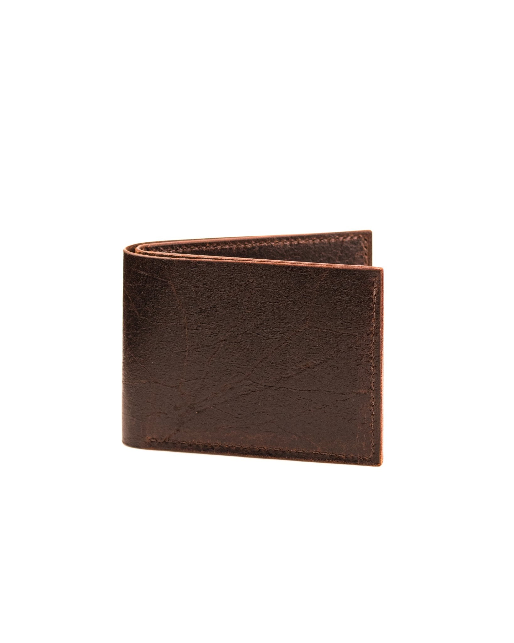 closed distressed brown leather wallet on a white background